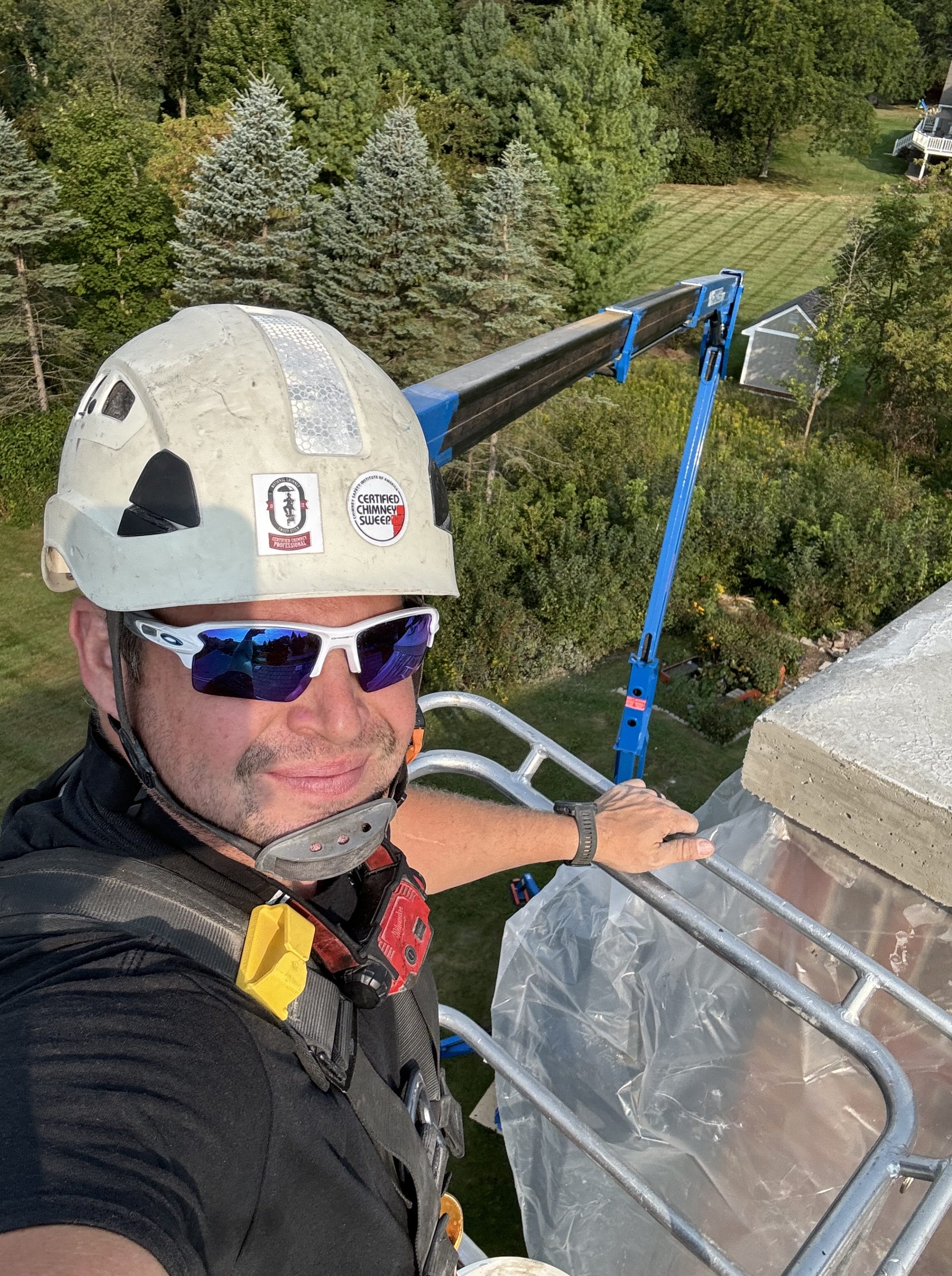 An original image of a Humble Sweeps technician working on a chimney.