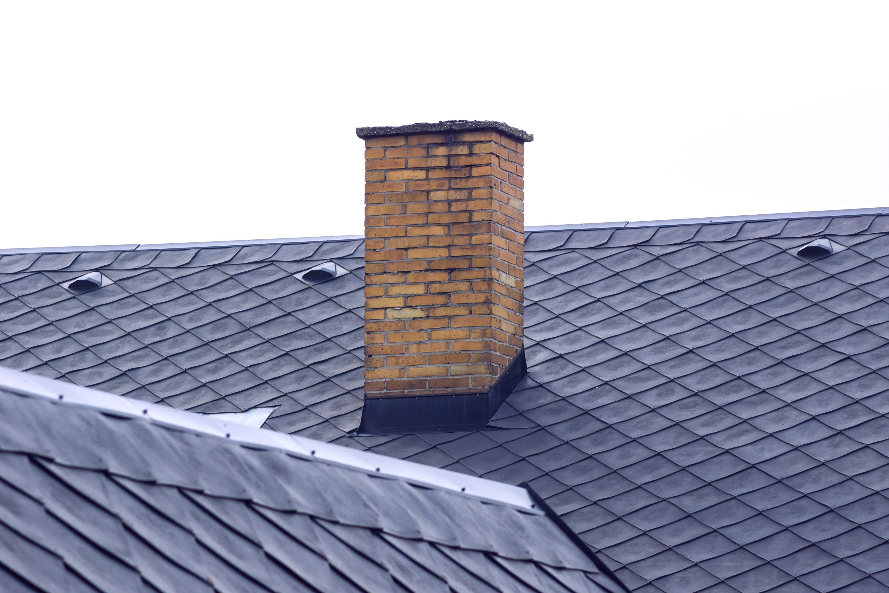 A stock image of a masonry chimney needing chimney services.
