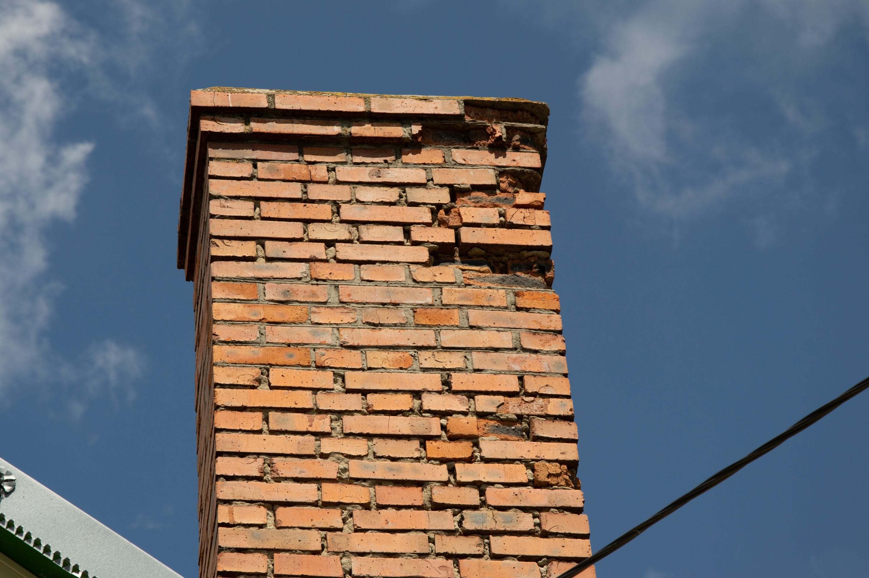 A stock image of broken down chimney needing masonry repair services.