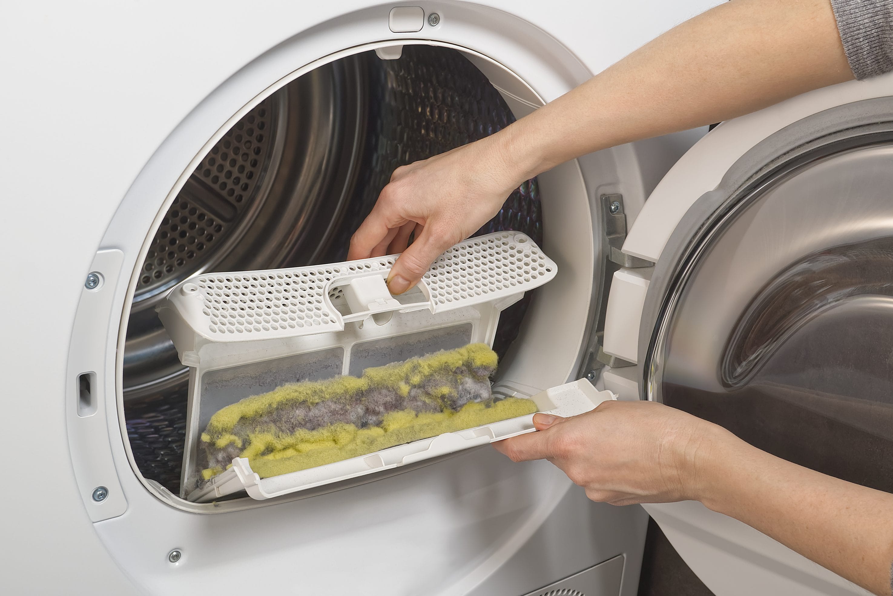 A stock image of dirty lint trap being emptied.