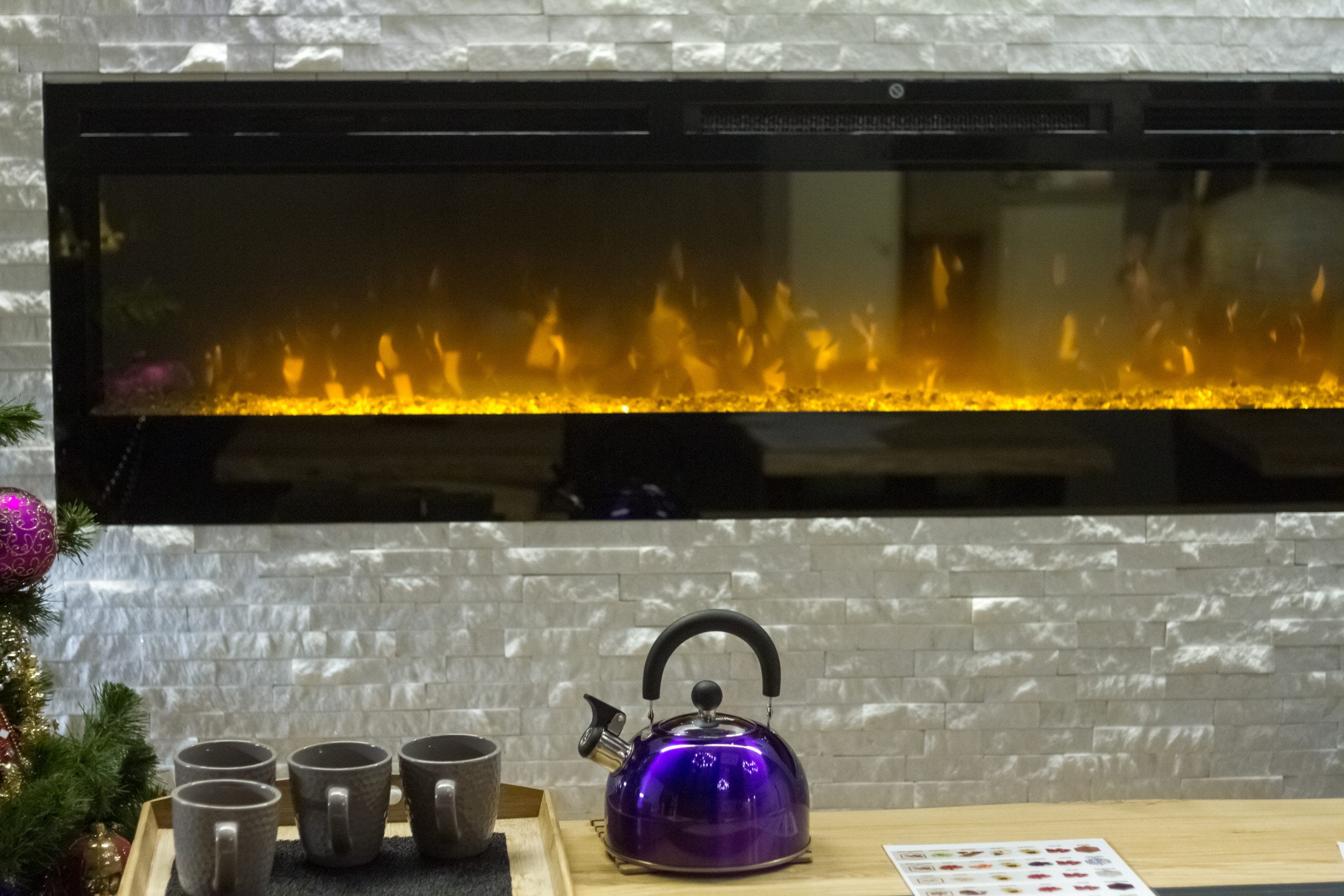 A stock image of an electric fireplace in a kitchen.