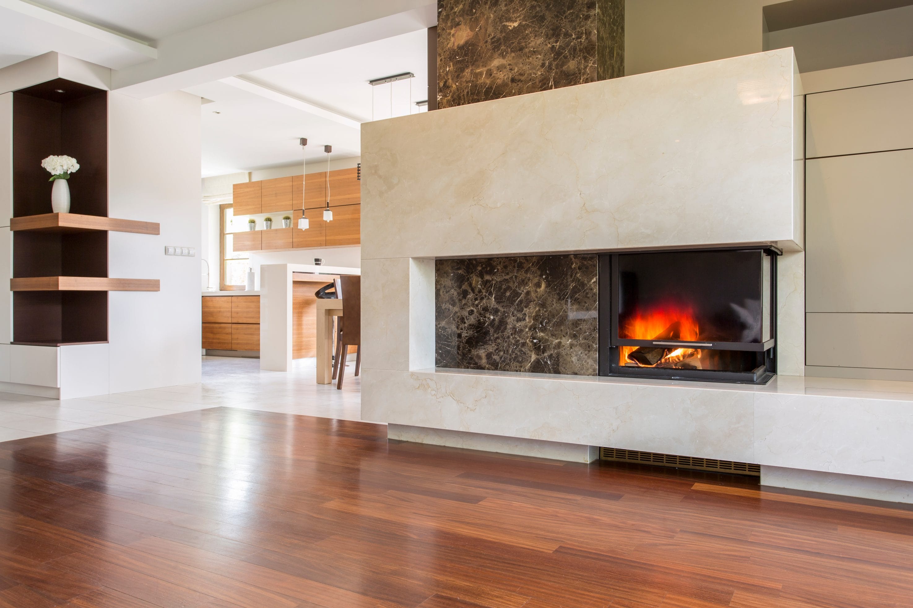 A stock image of recently installed fireplace in an open living room.